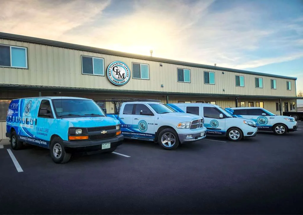 CRM-branded cleaning vehicles outside the company building